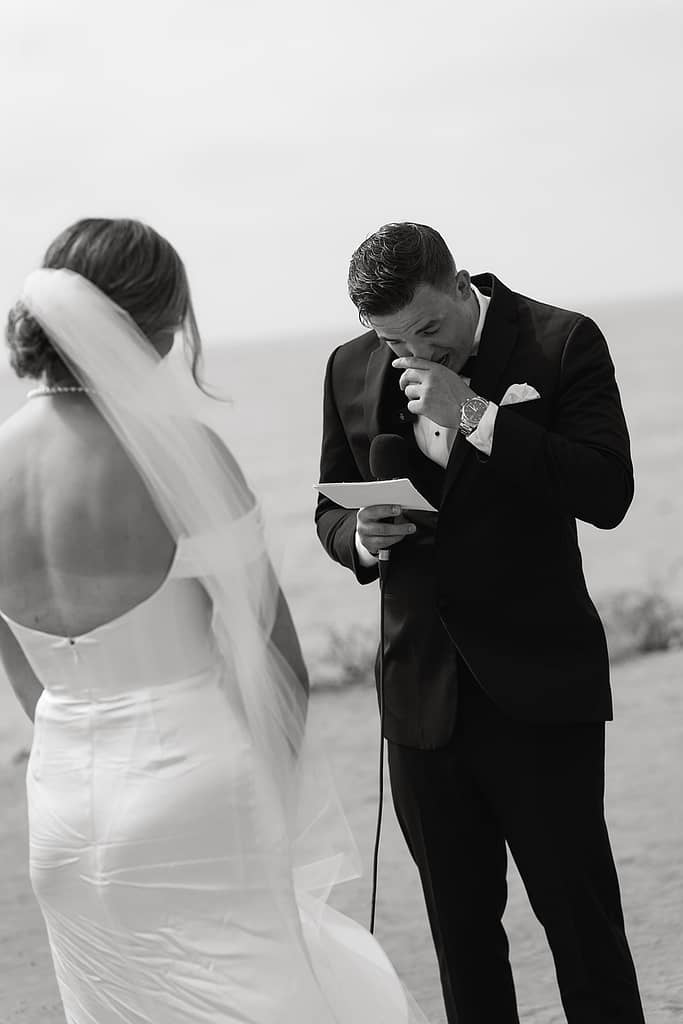 bride and groom reading vows during their sunset cliffs micro wedding