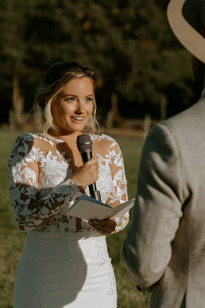 bride reading vows during orchard wedding ceremony