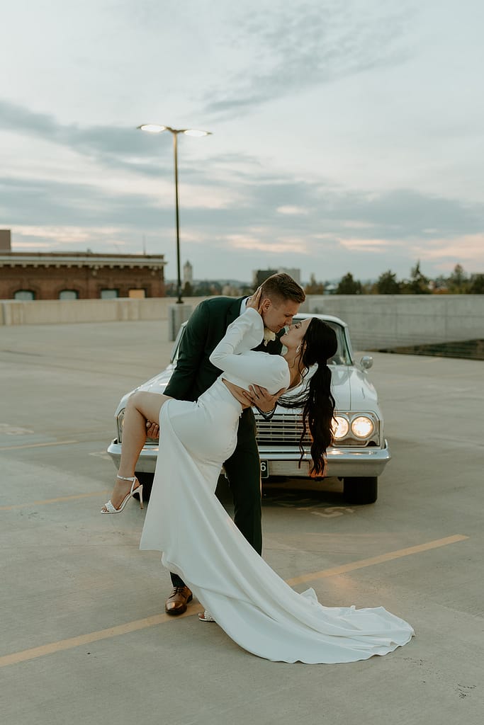 bride and groom with classic car on the rooftop after downtown elopement ceremony
