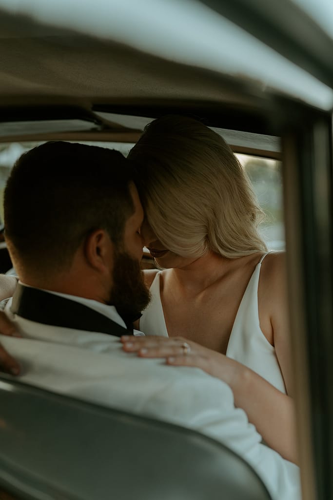 documentary style bride and groom in a vintage car