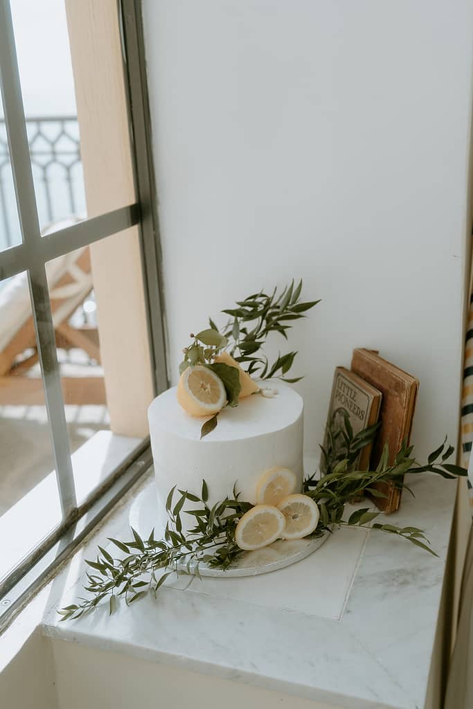 A close-up of a lemon-accented wedding cake, showcasing the citrusy details.
