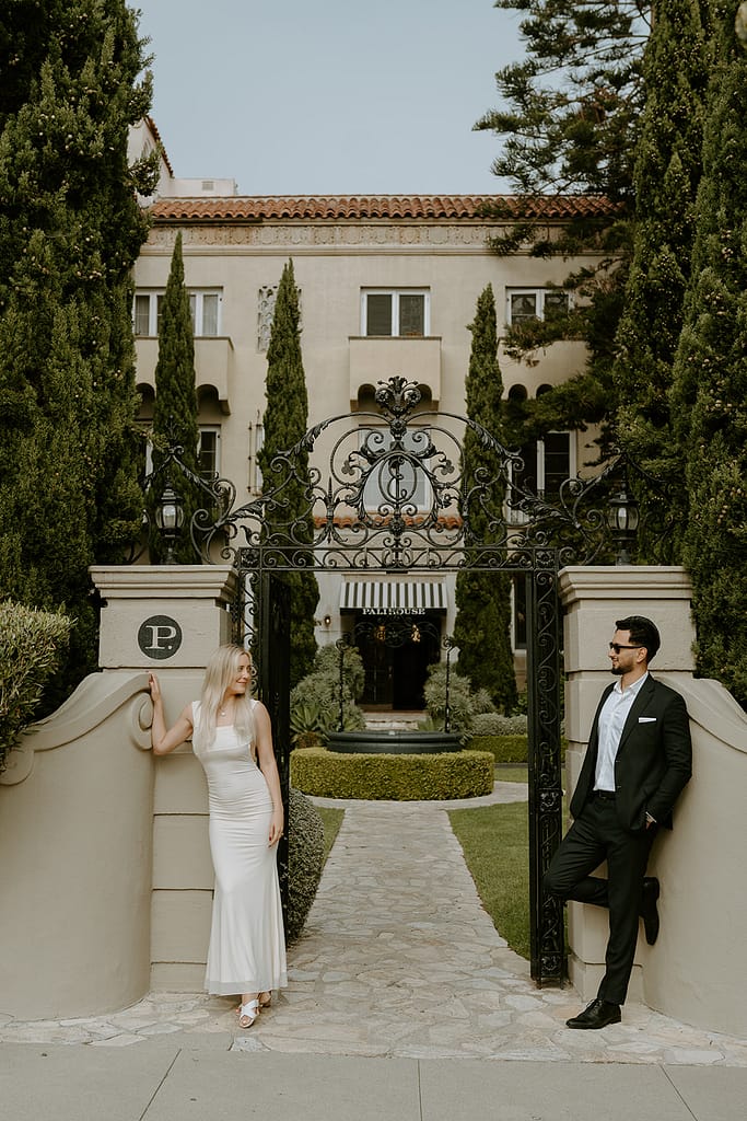 Warm and timeless outdoor engagement photo with the historic Pali House Hotel in the background.