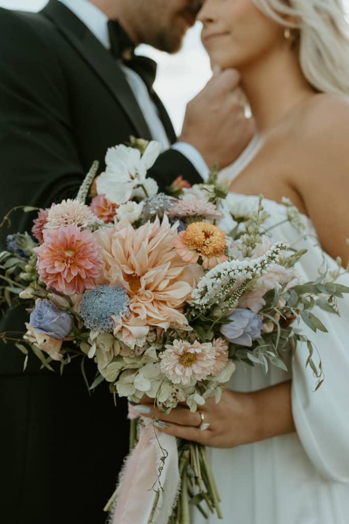 bride holding a wildflower elopement bouquet