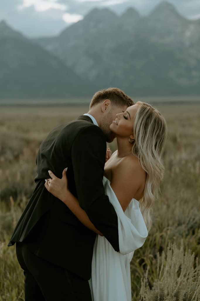 couple embraces near grand teton national park for their bridal portraits